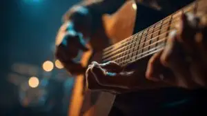 Close-up of a person’s hands playing an acoustic guitar, with warm stage lights blurred in the background, creating a moody and artistic atmosphere—perfectly capturing the passion found at East Orlando School of Music.